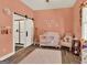 A charming Bedroom featuring wood-look tile floors and a barn door to the bathroom at 340 Cedar St, Social Circle, GA 30025