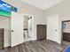 View of bedroom with wood-look tile floors that lead to a toilet room with marble flooring at 340 Cedar St, Social Circle, GA 30025