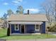 Inviting blue home with a covered front porch and a bench for relaxation at 340 Cedar St, Social Circle, GA 30025