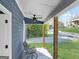 Relaxing front porch featuring a ceiling fan and decorative metal chair at 340 Cedar St, Social Circle, GA 30025