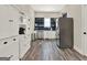 Modern kitchen with white cabinets, stainless steel appliances, and beautiful tile floors is great for cooking at 340 Cedar St, Social Circle, GA 30025