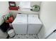 Well-equipped laundry area with modern machines and charming tile flooring for convenient chore days at 340 Cedar St, Social Circle, GA 30025