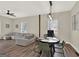 Spacious living and dining area with modern lighting, tile floors and a comfortable gray sectional sofa at 340 Cedar St, Social Circle, GA 30025