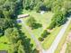Aerial view of the property, showing the house, outbuildings, and surrounding land at 677 Gum Creek Rd, Oxford, GA 30054