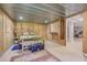 Basement bedroom featuring knotty pine walls, recessed lights, and doorway at 677 Gum Creek Rd, Oxford, GA 30054