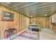 Basement bedroom featuring knotty pine walls and a cozy double bed at 677 Gum Creek Rd, Oxford, GA 30054