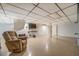 Finished basement with a TV, chair, and two entrances to other rooms at 677 Gum Creek Rd, Oxford, GA 30054
