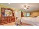 Bright bedroom featuring a wooden dresser and ceiling fan for added comfort at 677 Gum Creek Rd, Oxford, GA 30054