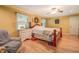 Bedroom featuring a wooden bed frame, ceiling fan, wood flooring, and natural light at 677 Gum Creek Rd, Oxford, GA 30054