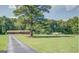 Well-maintained brick home with a spacious front yard and mature trees at 677 Gum Creek Rd, Oxford, GA 30054