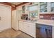 Efficient kitchen with ample counter space, white appliances, and stylish brick accents at 677 Gum Creek Rd, Oxford, GA 30054