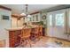 Eat-in kitchen features brick accents, barstool seating, and stylish lighting fixtures at 677 Gum Creek Rd, Oxford, GA 30054