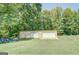 Large outbuilding with roll-up doors, providing ample storage or workshop space at 677 Gum Creek Rd, Oxford, GA 30054