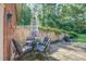 Back patio with outdoor seating area shaded by umbrella with a fire pit at 677 Gum Creek Rd, Oxford, GA 30054