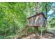 An elevated wooden treehouse with steps and a sign stating 'Private' at 677 Gum Creek Rd, Oxford, GA 30054