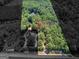 Aerial view of wooded lot, revealing a house and street at 2643 Rocky Creek Rd, Hampton, GA 30228
