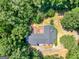 An aerial view of a wooded property with the house featuring a spacious deck at 2643 Rocky Creek Rd, Hampton, GA 30228