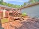 Multi-level back deck with steps leading up to the main deck and a wooded backyard at 2643 Rocky Creek Rd, Hampton, GA 30228