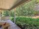 Back porch with a swing, table, and a view of trees at 2643 Rocky Creek Rd, Hampton, GA 30228