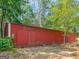 A red barn sits on the wooded property at 2643 Rocky Creek Rd, Hampton, GA 30228