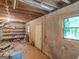 Unfinished basement with exposed ceiling and concrete walls, with window and door at 2643 Rocky Creek Rd, Hampton, GA 30228