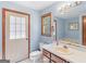 Bathroom features a toilet, sink, and a window, with a glimpse of a soaking tub at 2643 Rocky Creek Rd, Hampton, GA 30228