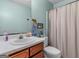 Well-decorated bathroom with a decorative mirror, toilet, and shower, creating a peaceful atmosphere at 2643 Rocky Creek Rd, Hampton, GA 30228