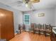 Bedroom area with a wooden door, window, ceiling fan, and hardwood floors at 2643 Rocky Creek Rd, Hampton, GA 30228