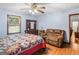 Cozy bedroom with a comfortable brown sofa, wooden floors, and lots of natural light at 2643 Rocky Creek Rd, Hampton, GA 30228