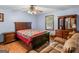 Well-appointed bedroom with a queen-sized bed, wooden furniture, and a window view at 2643 Rocky Creek Rd, Hampton, GA 30228