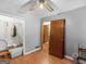 Bedroom with wood floors, a closet, a ceiling fan and a door to another room at 2643 Rocky Creek Rd, Hampton, GA 30228