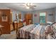 Comfortable bedroom featuring a decorative bed frame, wooden furniture, and lots of storage at 2643 Rocky Creek Rd, Hampton, GA 30228