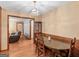 Dining area with wooden table and chairs, chandelier, and view of the living room at 2643 Rocky Creek Rd, Hampton, GA 30228