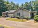 Exterior view of home with attached garage and side porch surrounded by mature trees at 2643 Rocky Creek Rd, Hampton, GA 30228