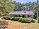 Ranch style home with mature trees and shrubs offering curb appeal at 2643 Rocky Creek Rd, Hampton, GA 30228