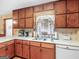 This kitchen features wood cabinets, white countertops, and a sink beneath a bright window at 2643 Rocky Creek Rd, Hampton, GA 30228