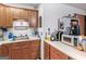 This kitchen features wood cabinets, white countertops, and various appliances at 2643 Rocky Creek Rd, Hampton, GA 30228