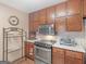 Well-lit kitchen featuring stainless steel appliances and wooden cabinets at 2643 Rocky Creek Rd, Hampton, GA 30228