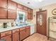 Charming kitchen with wood cabinets, white appliances, and a view from the window at 2643 Rocky Creek Rd, Hampton, GA 30228