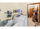 Functional laundry room equipped with a washer, dryer, sink, and storage racks for organization at 2643 Rocky Creek Rd, Hampton, GA 30228
