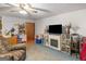 Cozy living room featuring a fireplace, TV, and comfortable seating area with blue carpet at 2643 Rocky Creek Rd, Hampton, GA 30228