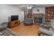 Inviting living room featuring a fireplace, built-in bookshelves, and laminate flooring at 2643 Rocky Creek Rd, Hampton, GA 30228