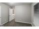 Bedroom with carpeted floor, neutral walls, window with blinds, and a white door at 323 Lauren Dr, Fairburn, GA 30213