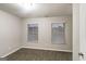 Bedroom with carpeted floor, neutral walls, and two windows with blinds for ample light at 323 Lauren Dr, Fairburn, GA 30213