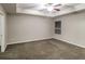 The bedroom features a tray ceiling, soft carpet, and a window offering natural light at 323 Lauren Dr, Fairburn, GA 30213