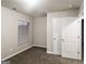Bedroom showcasing double-door closet, carpeted floor, neutral walls, and window with blinds at 323 Lauren Dr, Fairburn, GA 30213