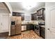 Modern kitchen equipped with stainless steel appliances, granite countertops and dark cabinets at 323 Lauren Dr, Fairburn, GA 30213