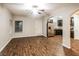 Spacious living room featuring wood-look floors and arched doorways leading to kitchen and dining areas at 323 Lauren Dr, Fairburn, GA 30213