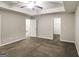 Spacious main bedroom featuring neutral colors, carpeted floor, and ceiling fan with light fixture at 323 Lauren Dr, Fairburn, GA 30213