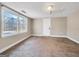 Basement showcasing neutral walls, carpet, a window overlooking the back yard, and an access door at 927 Dean Patrick Rd, Locust Grove, GA 30248